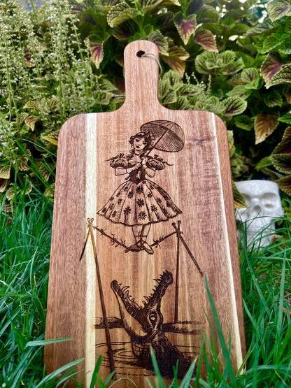 Charcuterie & Cutting Board - The Doomed Tightrope Walker from the stretching room!  Sally Slater 16” X 8” engraved on Acaci