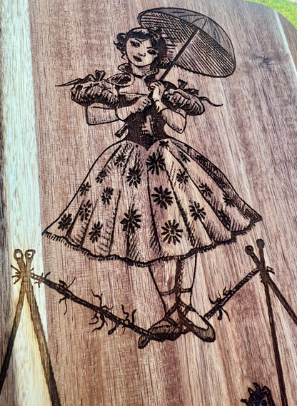 Charcuterie & Cutting Board - The Doomed Tightrope Walker from the stretching room!  Sally Slater 16” X 8” engraved on Acaci